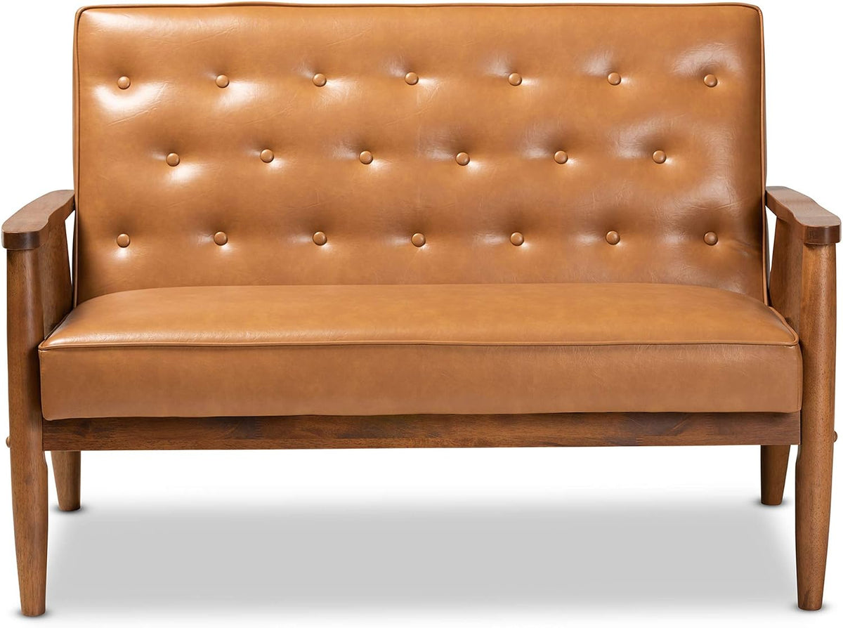 Straight front view of tan faux leather loveseat highlighting the button-tufted back and seat