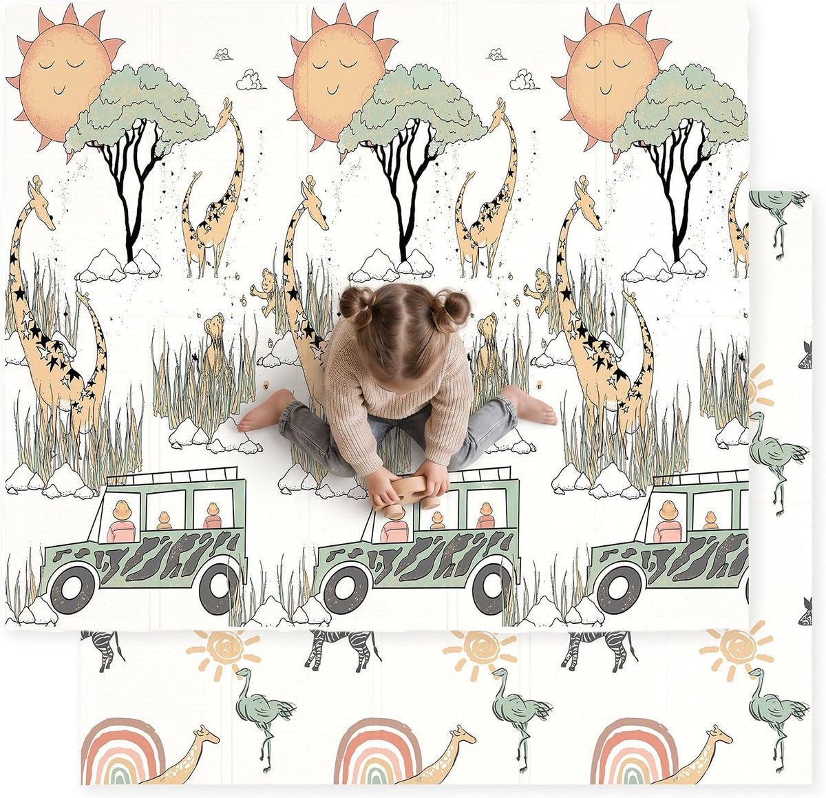 Overhead photo of a child sitting on a white play mat featuring giraffes, a green jeep and tall grass with animal prints