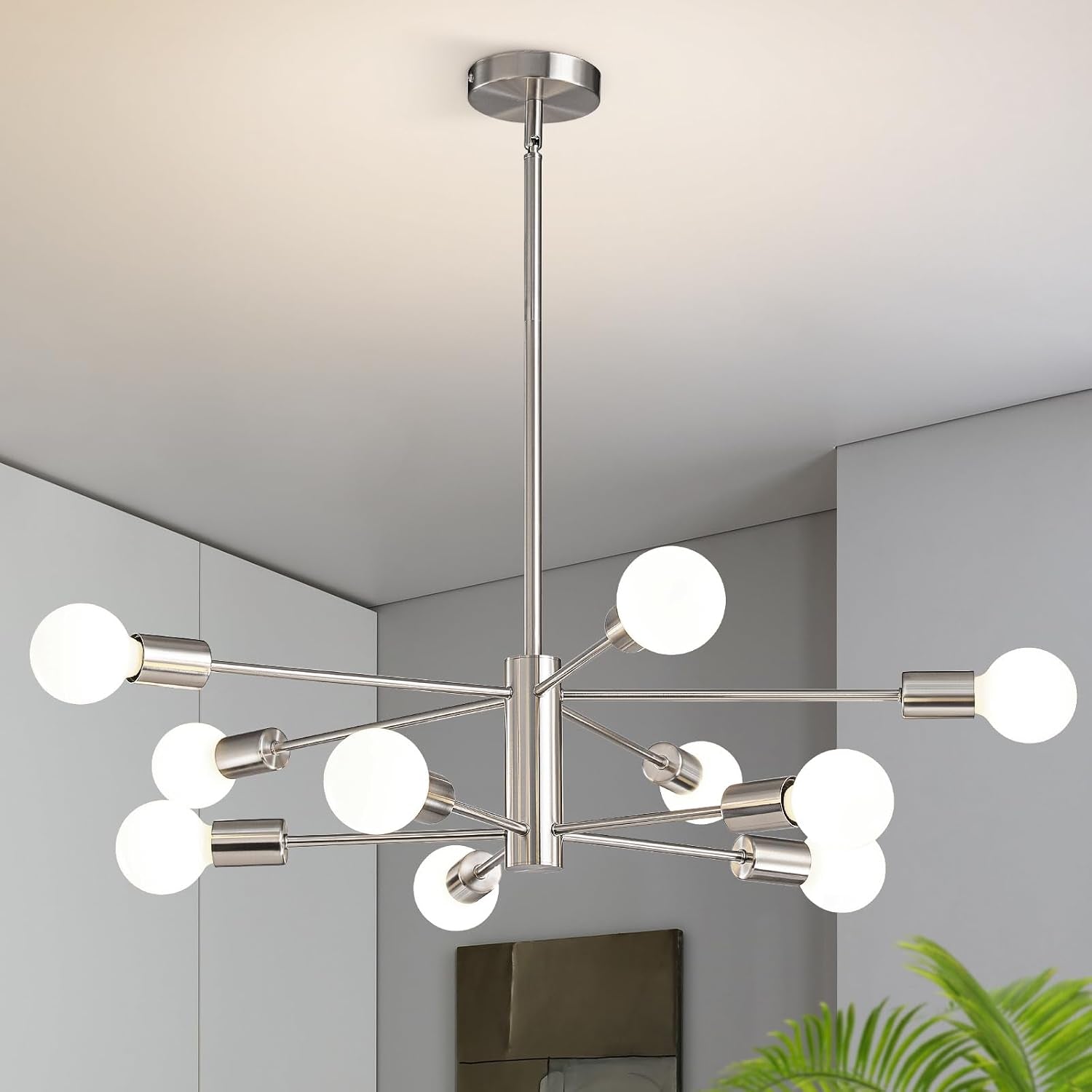 Silver sputnik chandelier with twelve frosted globe bulbs suspended from a ceiling.