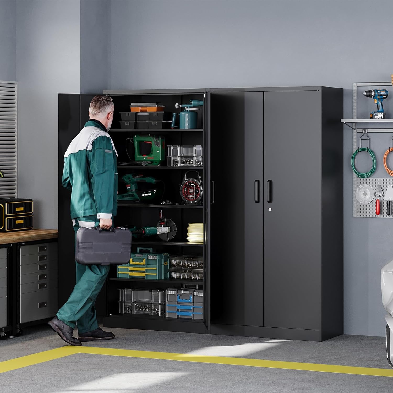 Person in green coveralls accessing an open black metal storage cabinet beside a closed cabinet in a garage workspace, side‑f