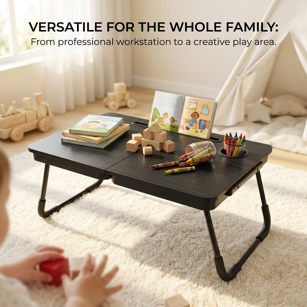 Black lap desk low on a rug used as a play surface with books, wooden blocks and crayons on top
