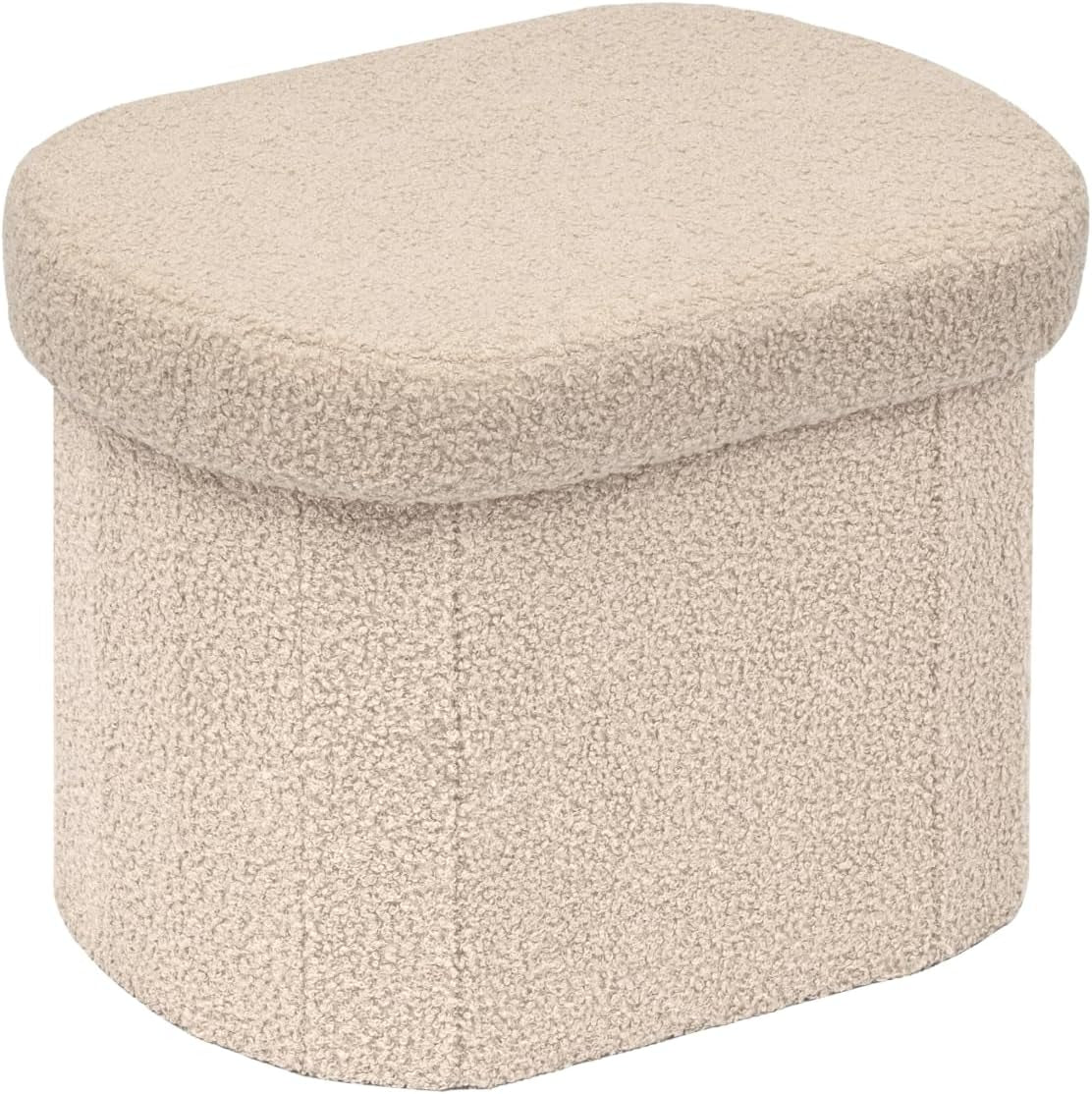 Rounded rectangular storage ottoman in cream sherpa fabric, angled to show curved edges.