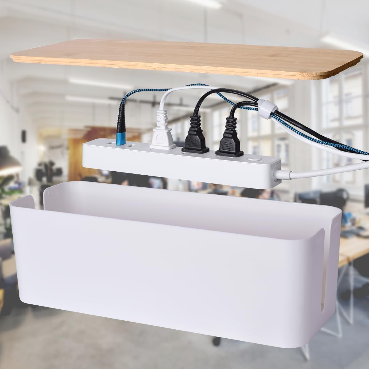 White cable box with bamboo lid removed showing a power strip and multiple cords inside against an office background