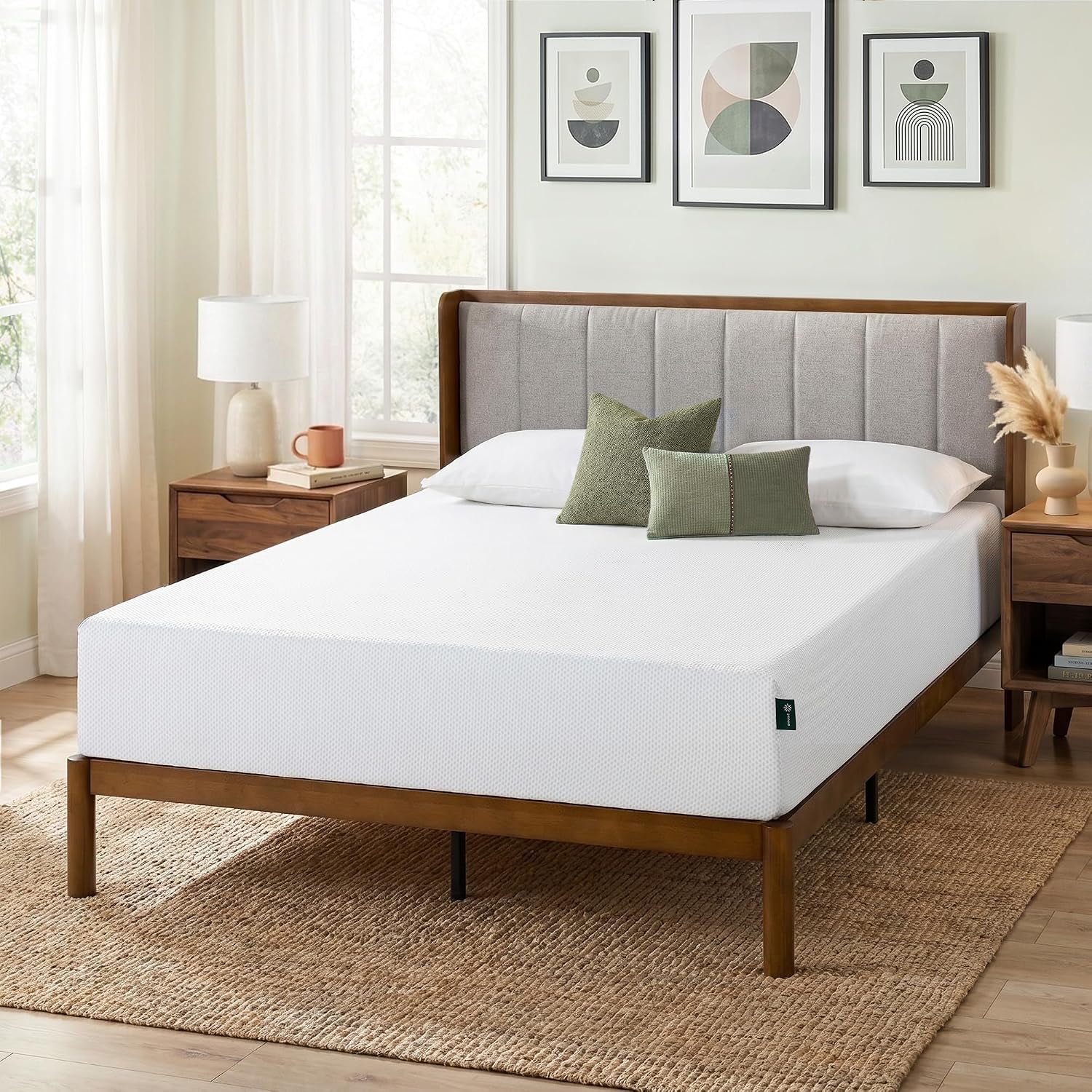 White memory foam mattress on a wooden bed frame in a bright bedroom, angled front view.