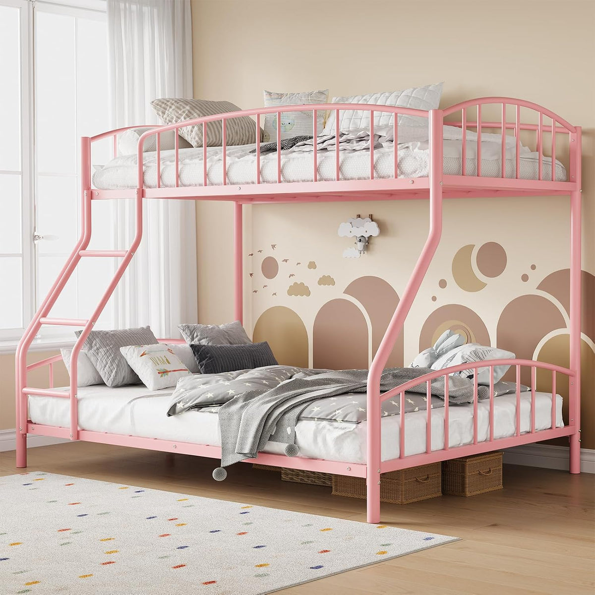 Pink metal twin-over-full bunk bed with angled ladder, shown in a neutral bedroom with patterned rug.