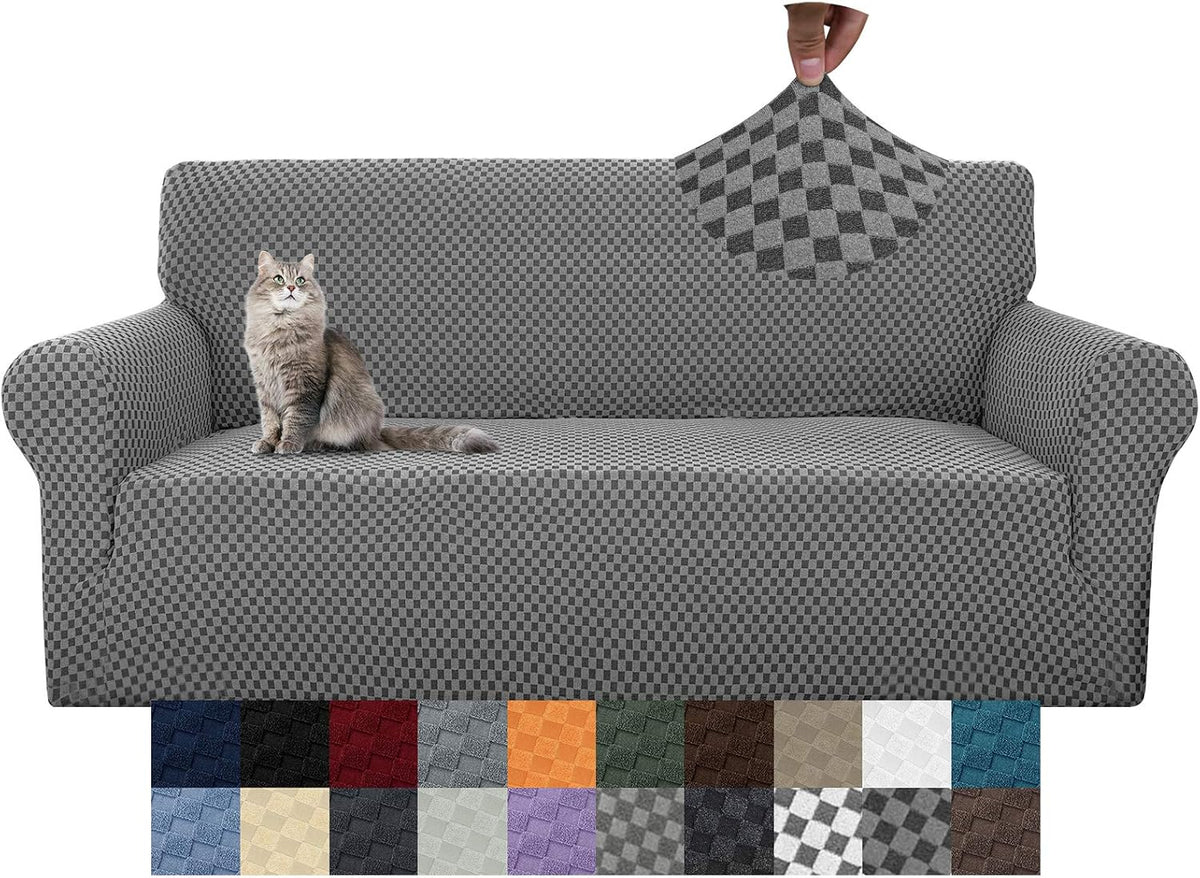 Two-seat sofa covered in gray checker-pattern stretch slipcover with a cat on the left cushion