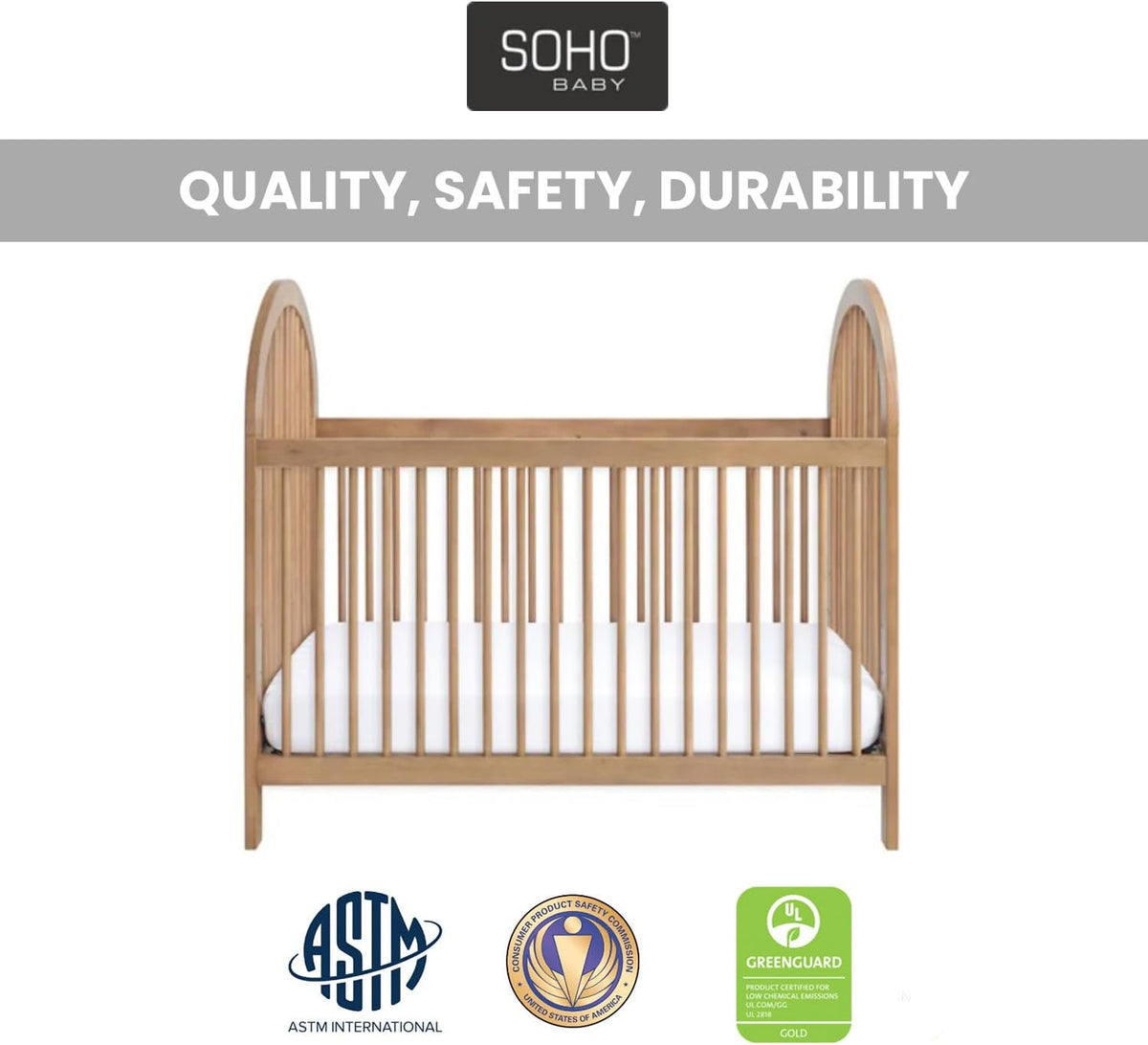 Front view of a honey wood convertible crib with rounded end panels and white mattress, logos below
