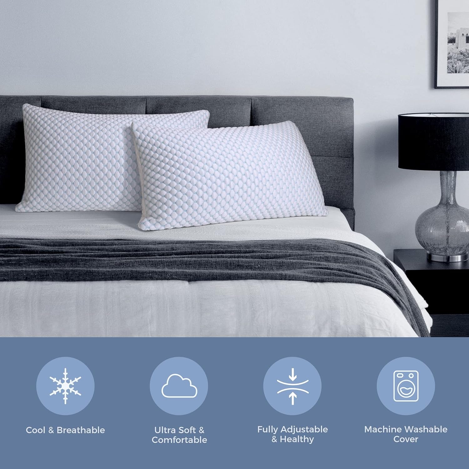 Two white textured pillows arranged on a made bed with an upholstered headboard in a neutral bedroom scene