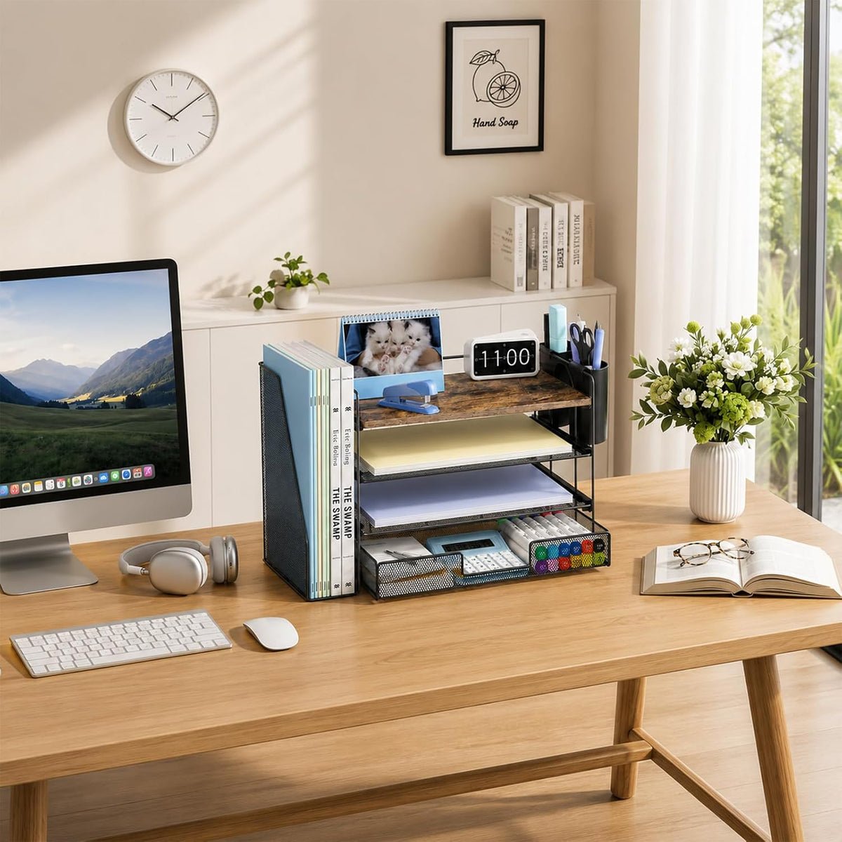 Workspace view of black desktop file organizer filled with notebooks, stapler and pens
