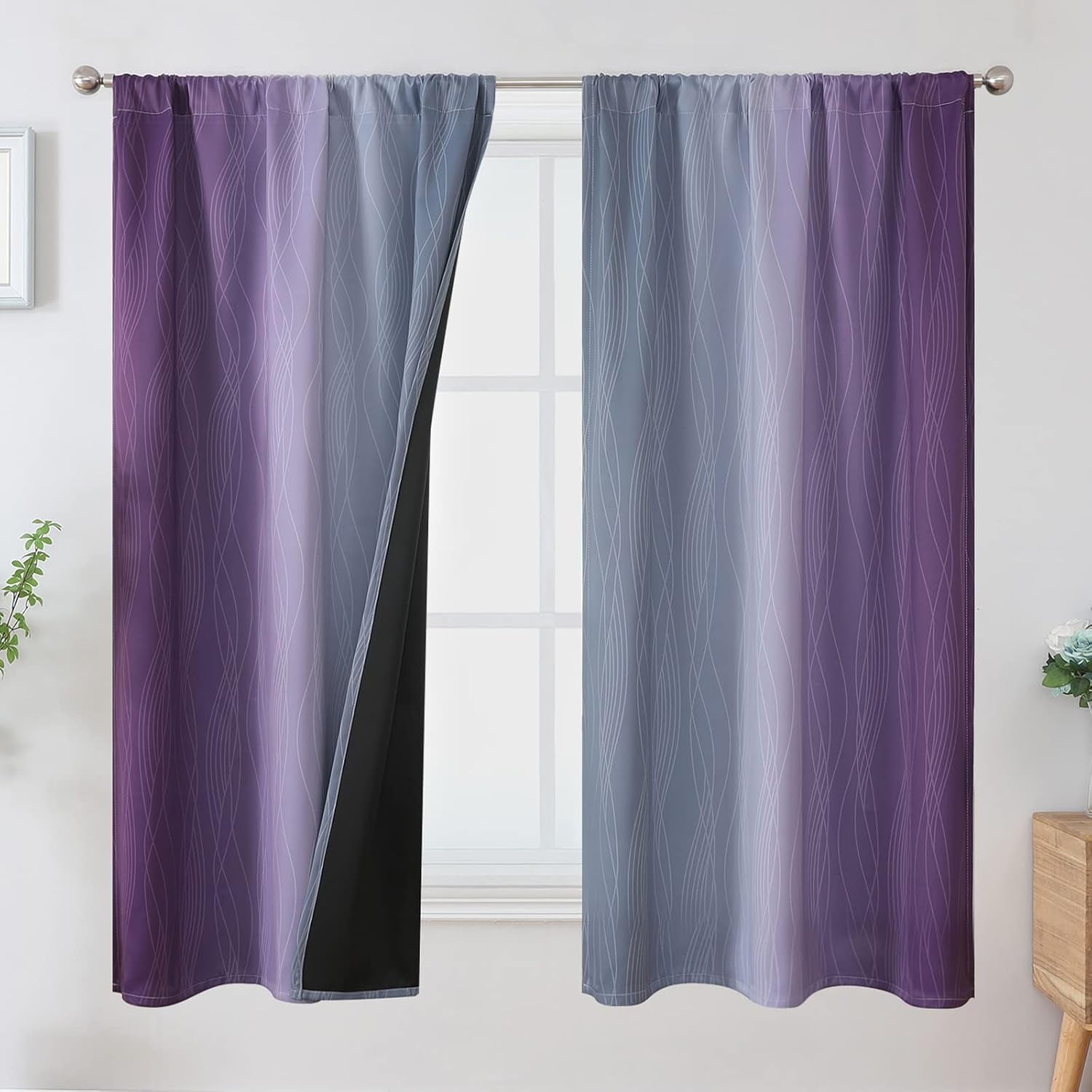 Pair of rod-pocket ombre curtains in purple-to-gray gradient with subtle wavy pattern, one panel slightly pulled to show