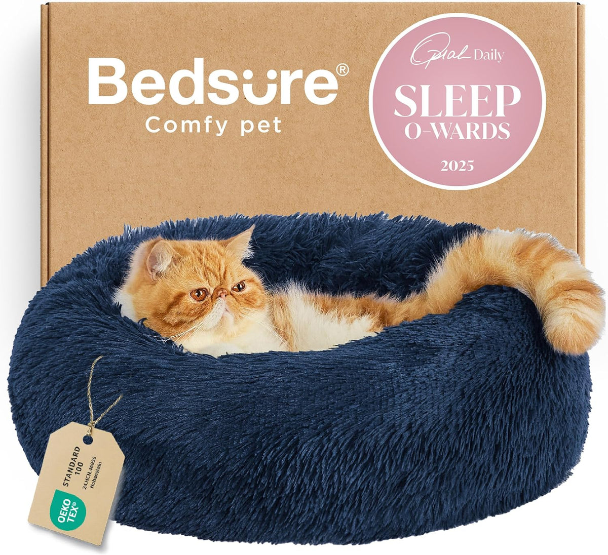 Top-side view of a navy faux-fur donut bed with a ginger flat-faced cat reclining and its tail curled over the rim.