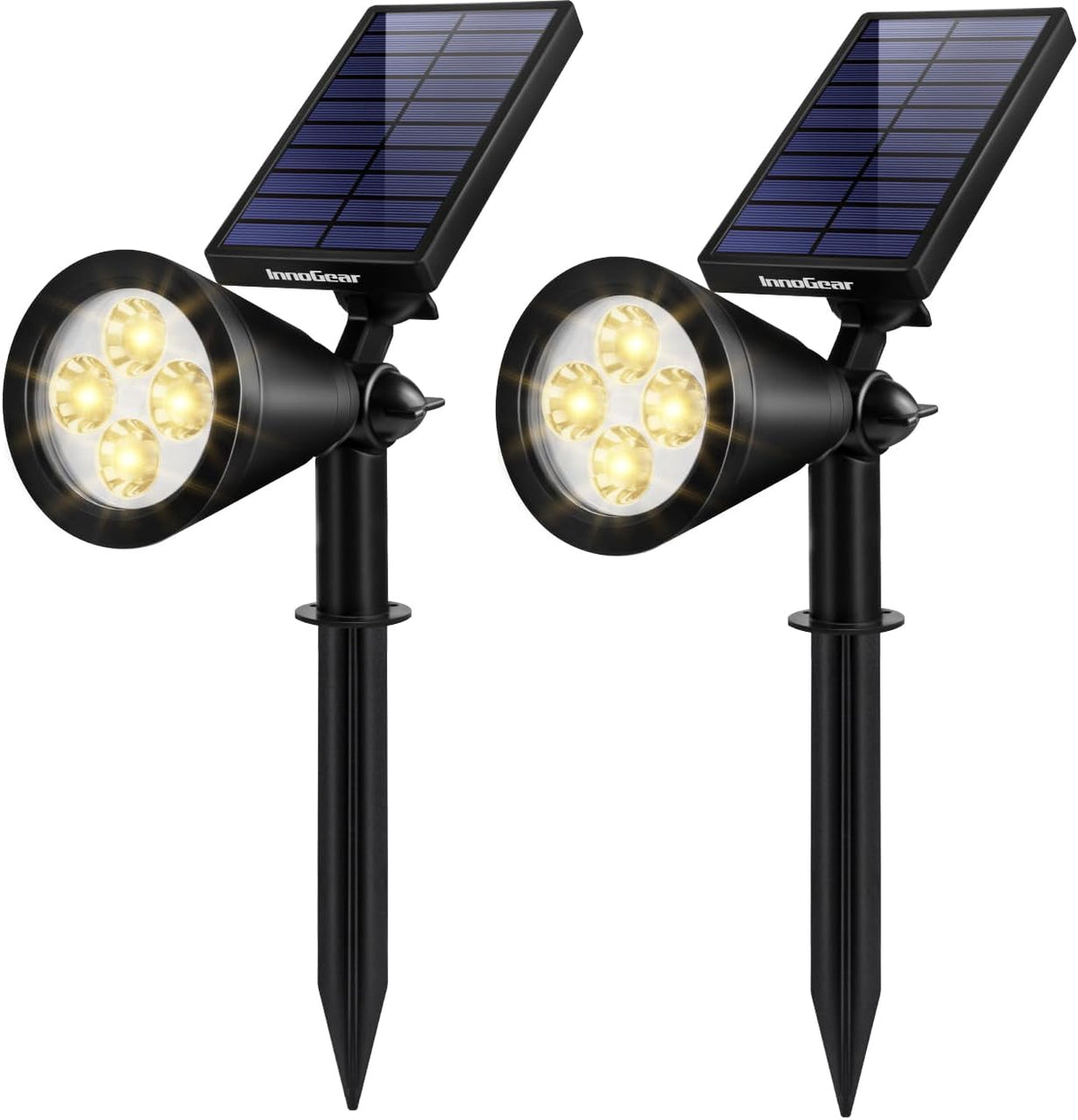 Pair of black solar spotlights on stakes with angled panels and four warm LEDs each