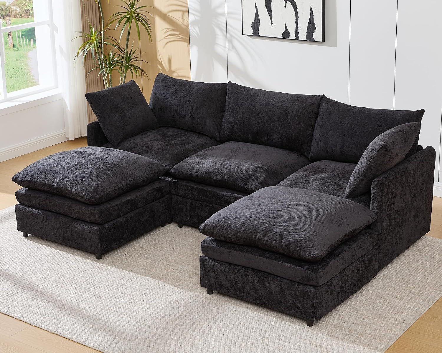 Dark gray three-seat U-shaped sectional with two ottomans.