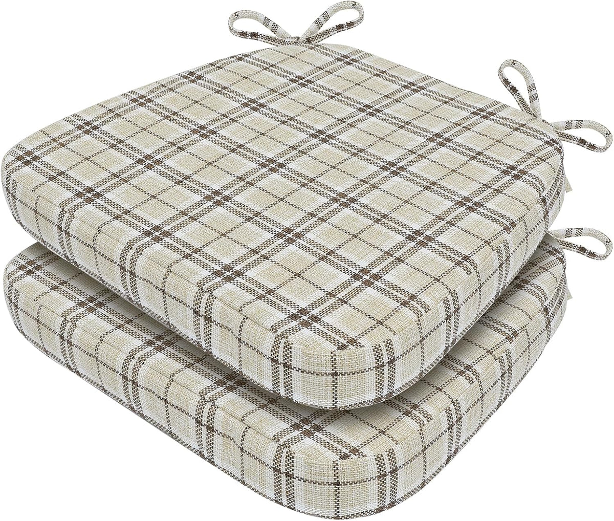 Two stacked chair cushions in a beige and brown plaid fabric showing corner ties and rounded D-shape.