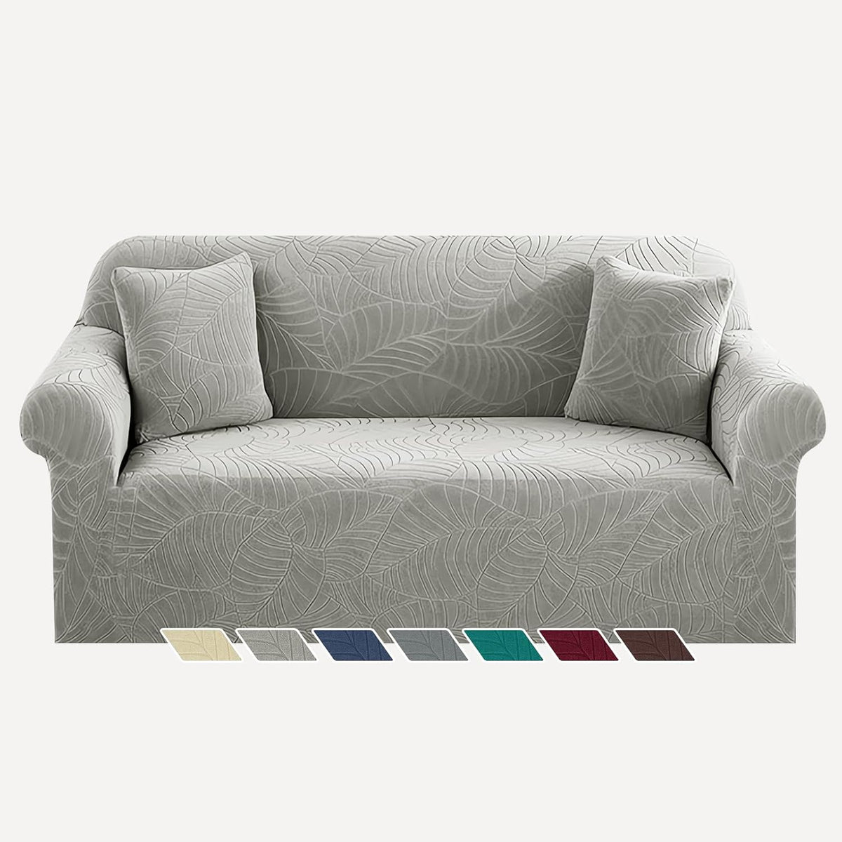 Front view of a three-seat sofa in light gray leaf-pattern slipcover with two matching square pillows and color swatches