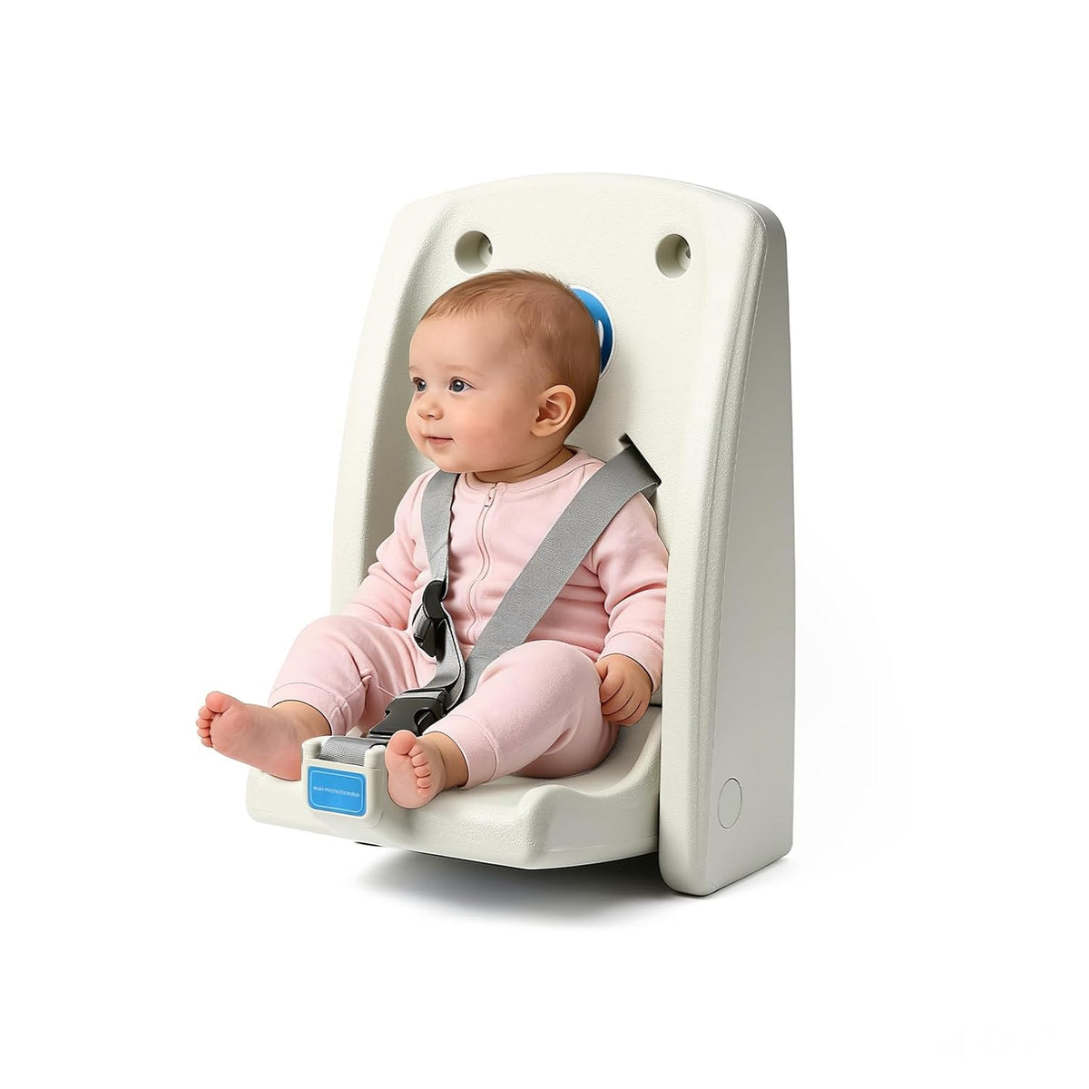 Baby seated in a wall-mounted fold-down changing station with gray safety straps, shown on a white background.