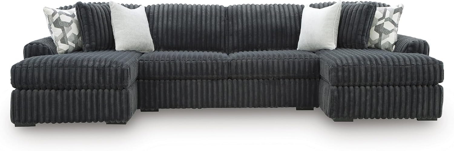 Front-facing wide shot of a large modular chaise sofa with ribbed jumbo-corduroy upholstery and four throw pillows.