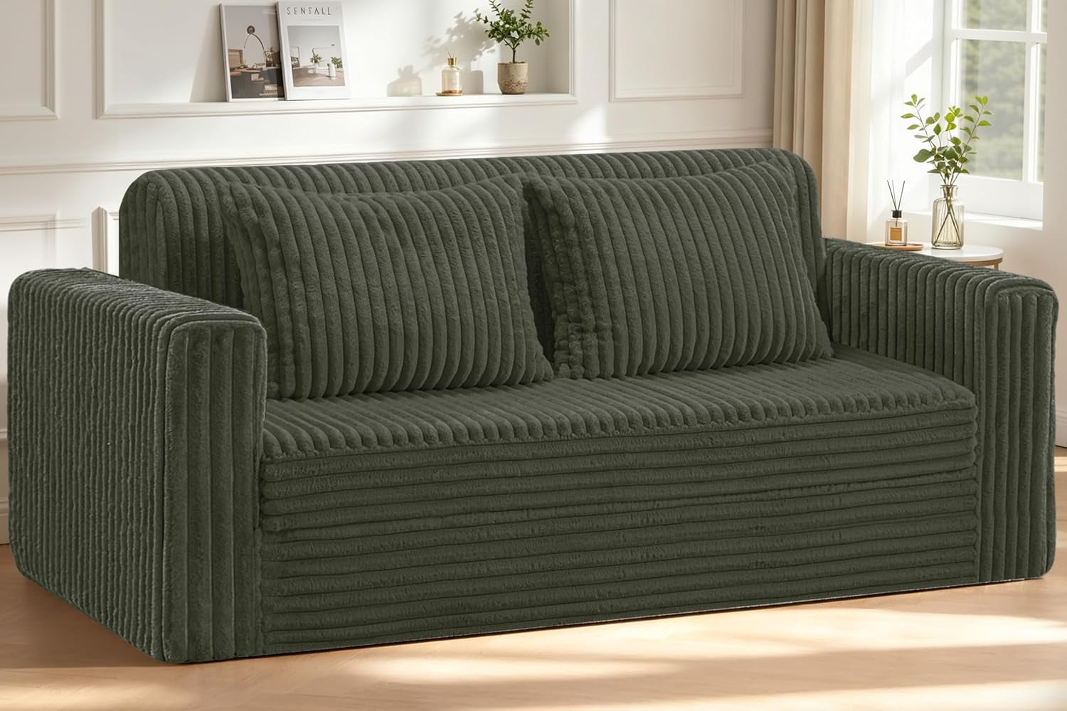 Front view of a dark green ribbed plush loveseat with two matching cushions in a bright room.