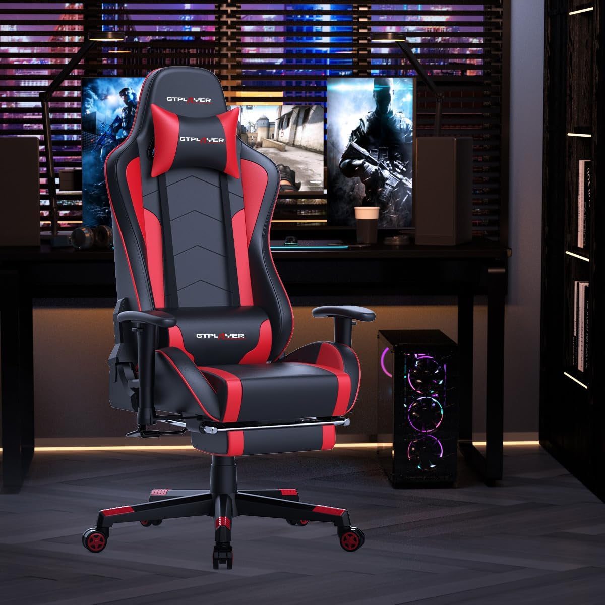 Red and black gaming chair front view placed in a dark gaming room setting by a monitor