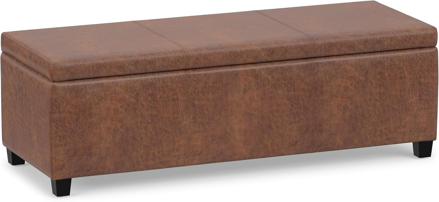 Warm tan distressed-look rectangular storage ottoman shown at an angle on white background.