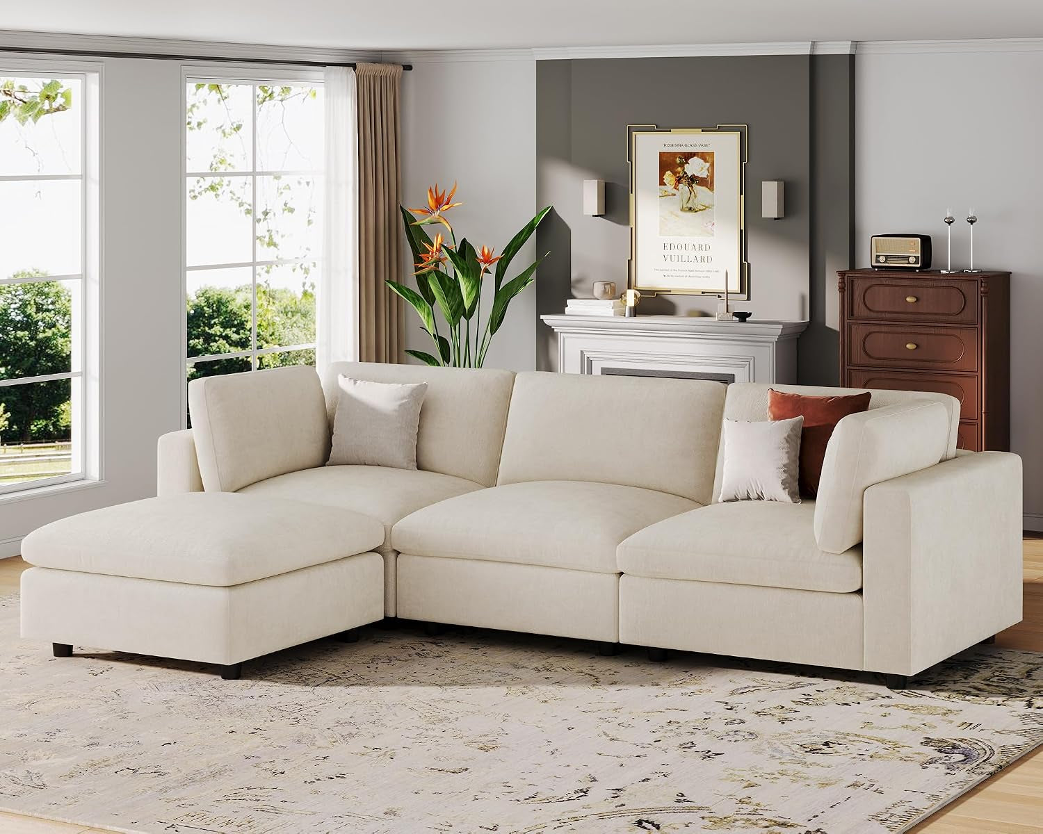 Angled shot of the L-shaped cream sectional with the chaise on the left and throw pillows near the armrest.