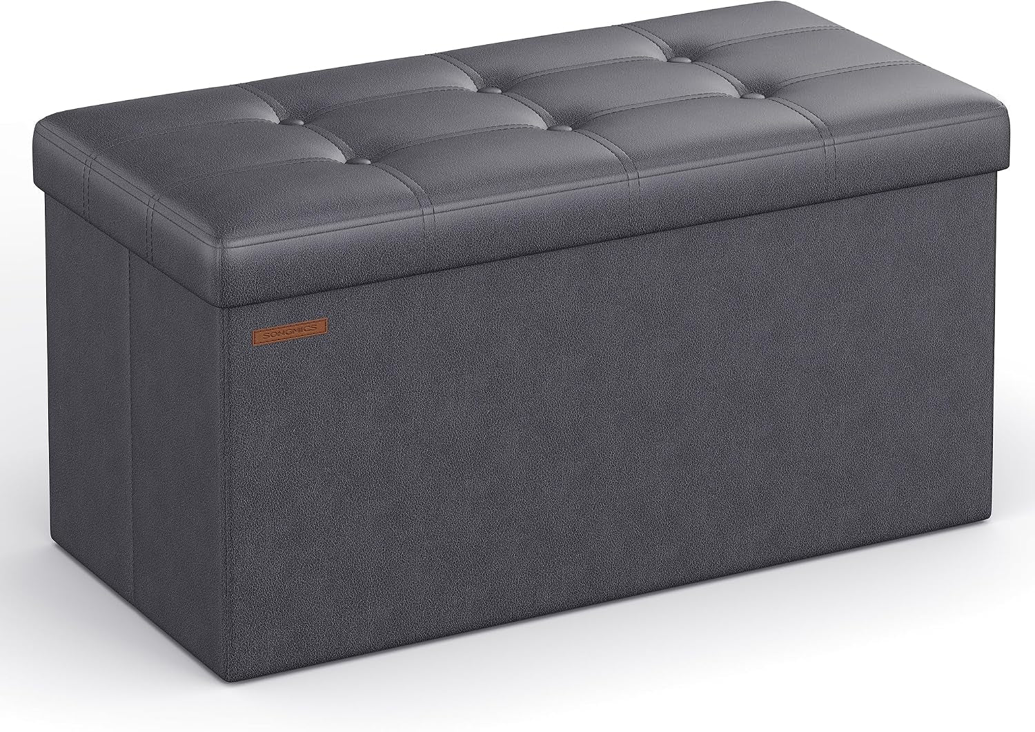 Three-quarter front view of a charcoal gray tufted faux-leather storage bench on white background.