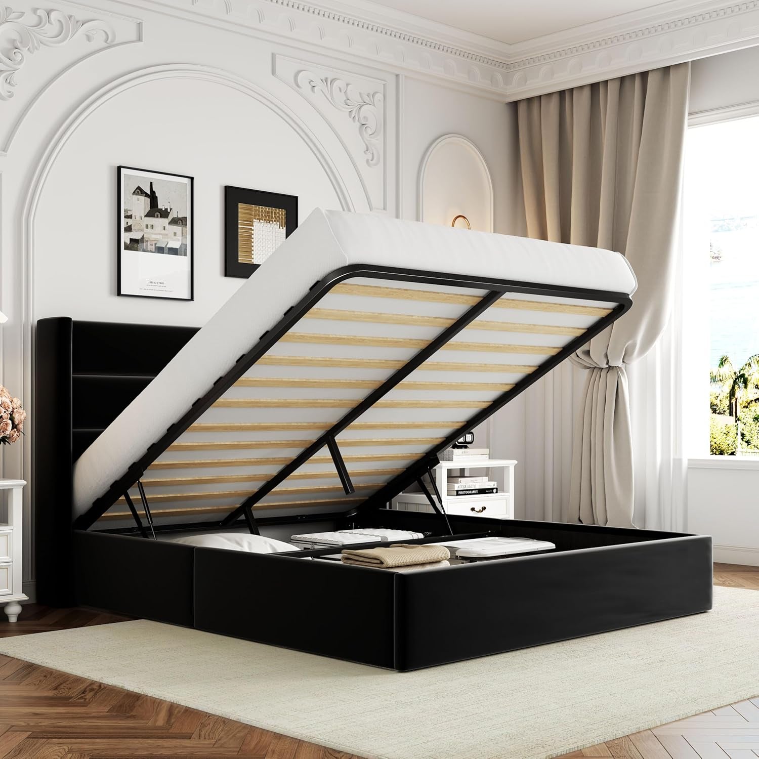 Black upholstered storage bed with mattress raised to expose organized storage, photographed in a decorated room.