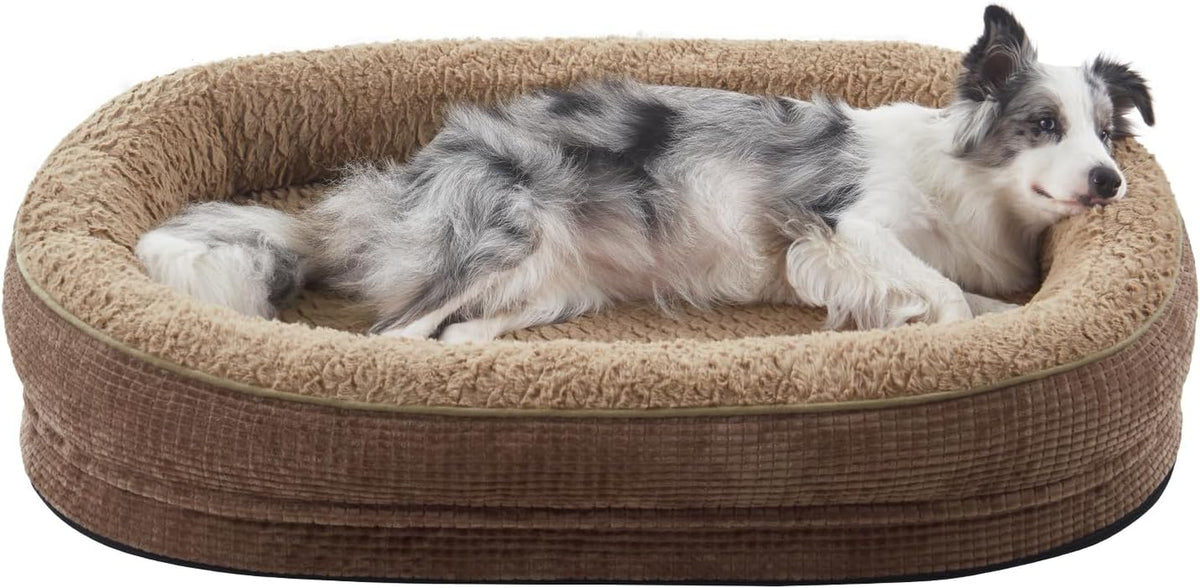 Tan oval dog bed with fluffy inner bolster and a relaxed dog resting its head on the rim