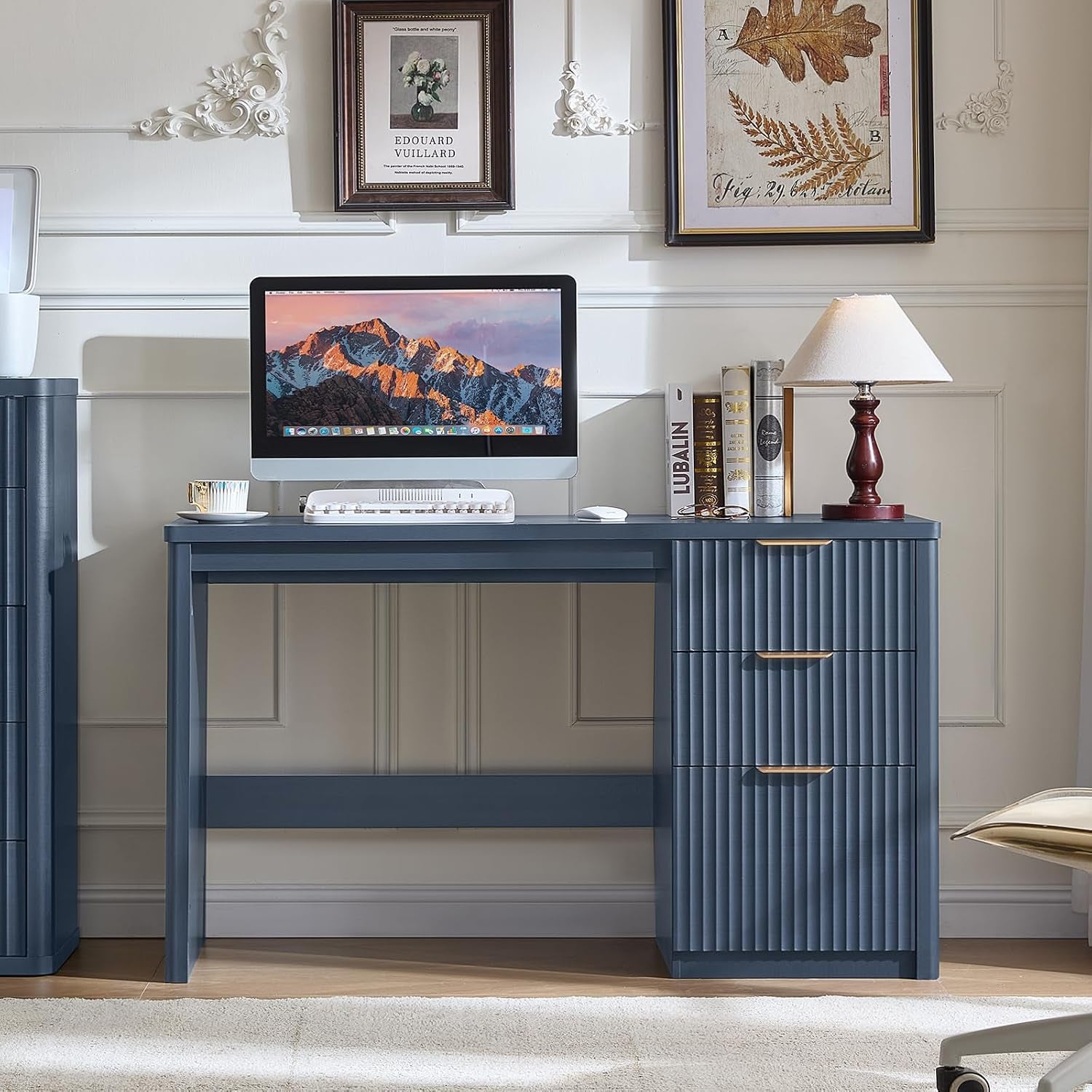 Navy blue desk front view with computer monitor and lamp on top in a decorated room