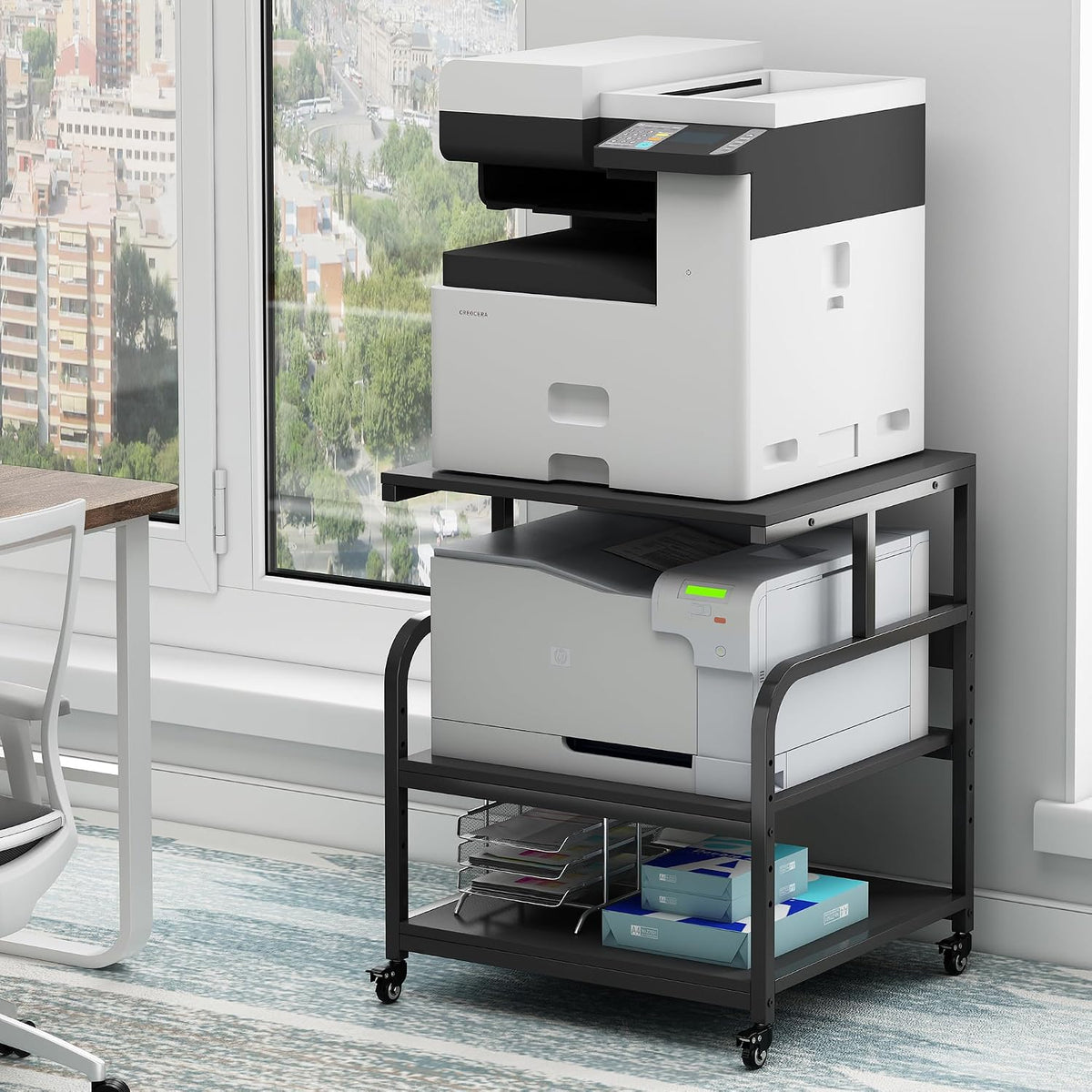 Angled close view of the black steel stand showing the lower shelf paper ream and casters on a patterned rug.