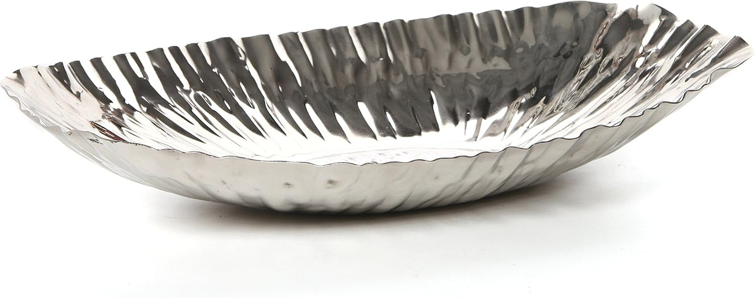 Eye-level side view of a shallow hammered oval bowl with elongated rippled interior and scalloped edges.