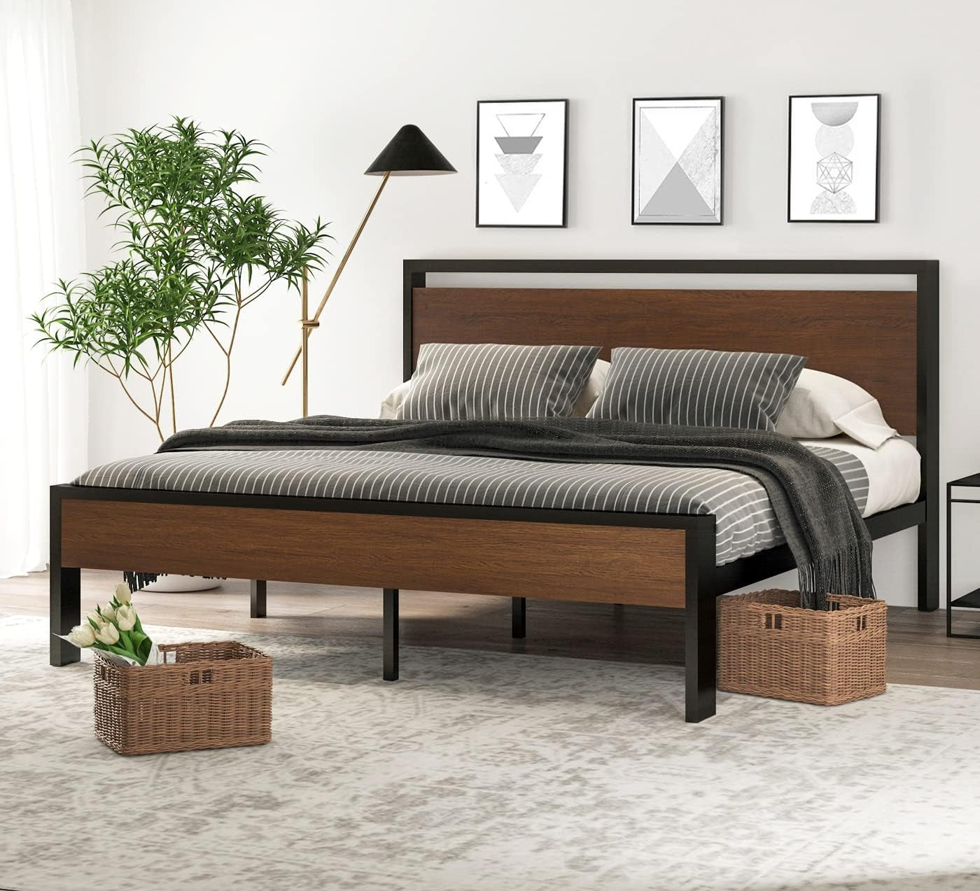 Side-front view of a black-framed bed with medium brown wood inset panels and striped bedding