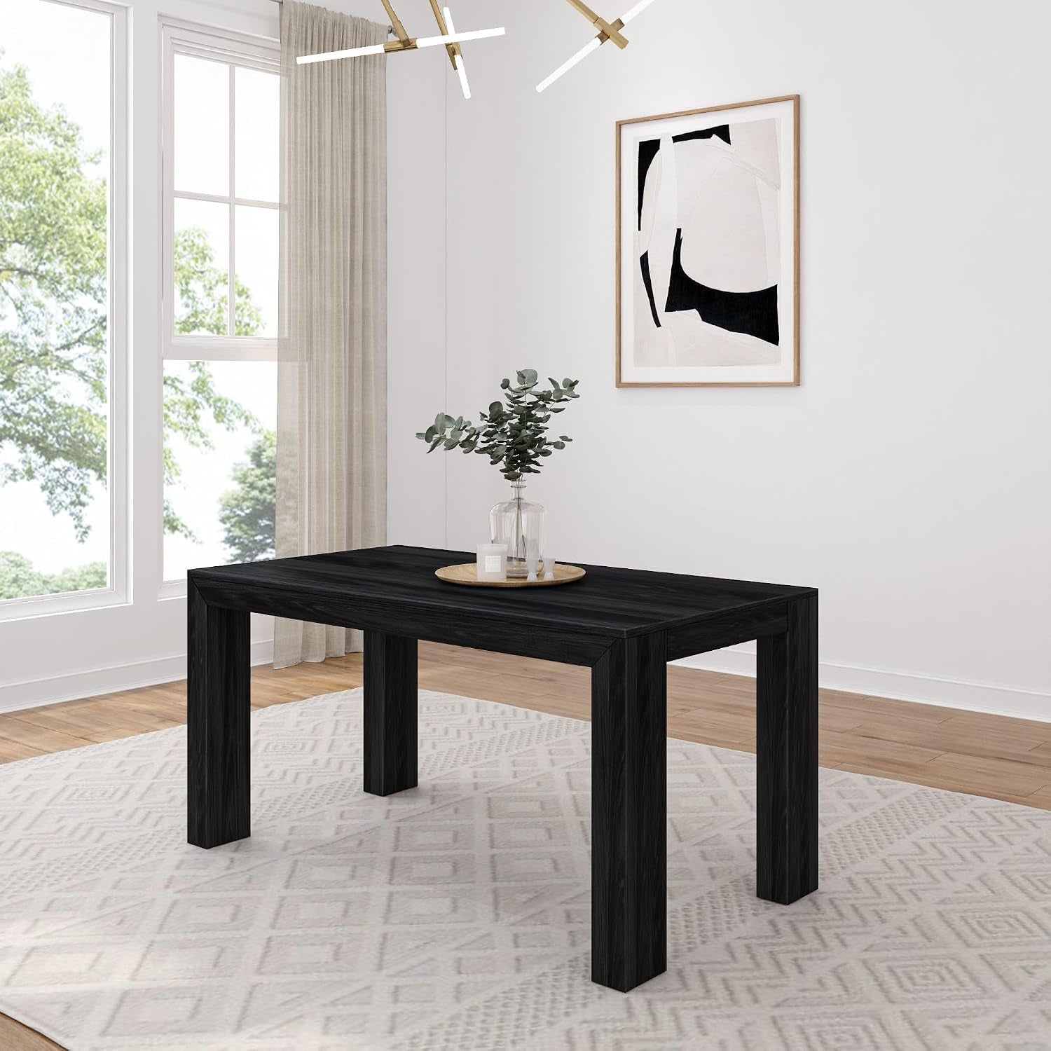 Rectangular dining table in a deep black wood finish placed on a patterned rug near a large window