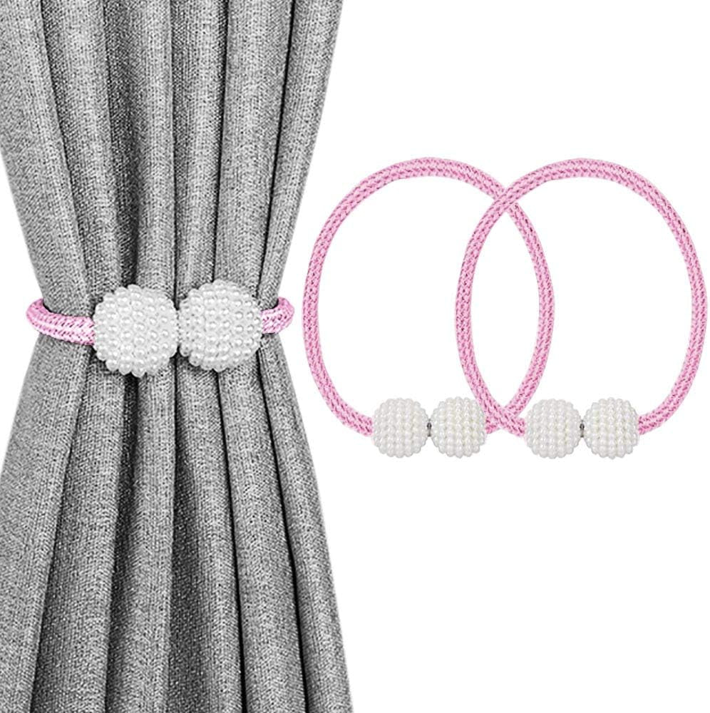 Gray curtain tied with a pink rope tieback featuring textured pearl cluster balls and two matching pink rings