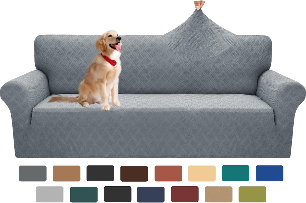 Light-gray stretch slipcover on a sofa with a golden retriever seated and a hand pinching the top back fabric to show
