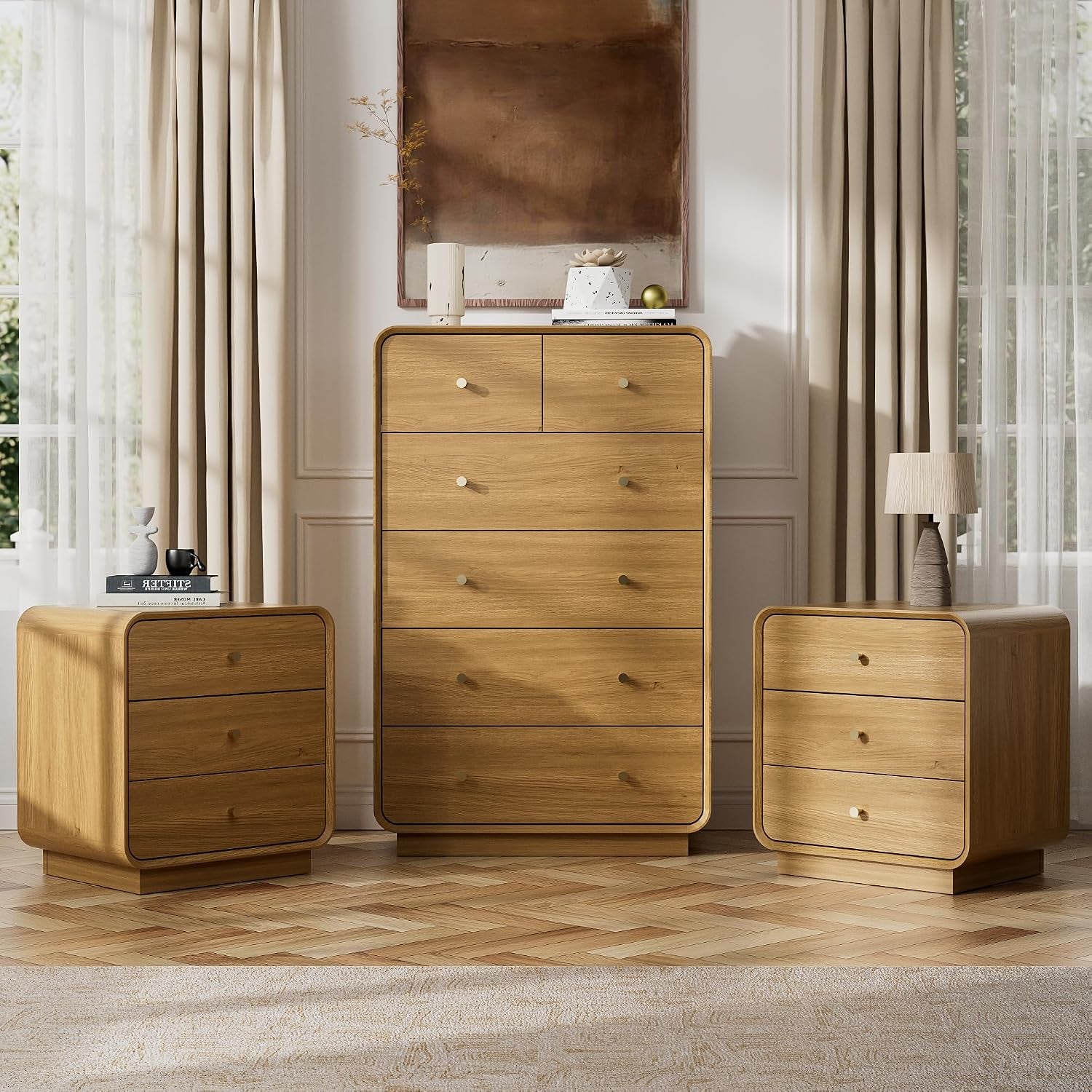 Tall oak chest centered with matching oak nightstands on a parquet floor
