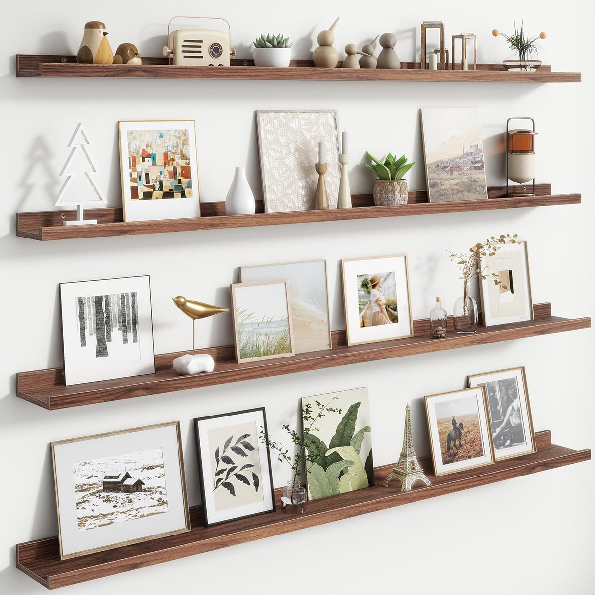 Angled view of three warm wood floating ledges holding framed prints, small sculptures and plants.