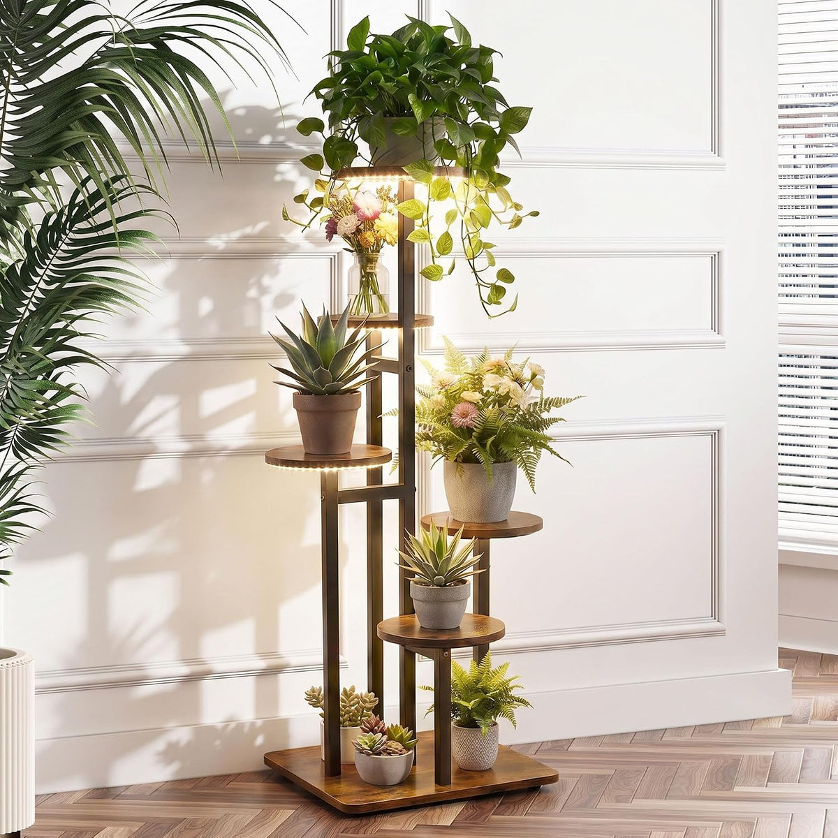 Close-up of staggered round shelves showing warm LED grow lights under each shelf with potted plants against a white paneled墙