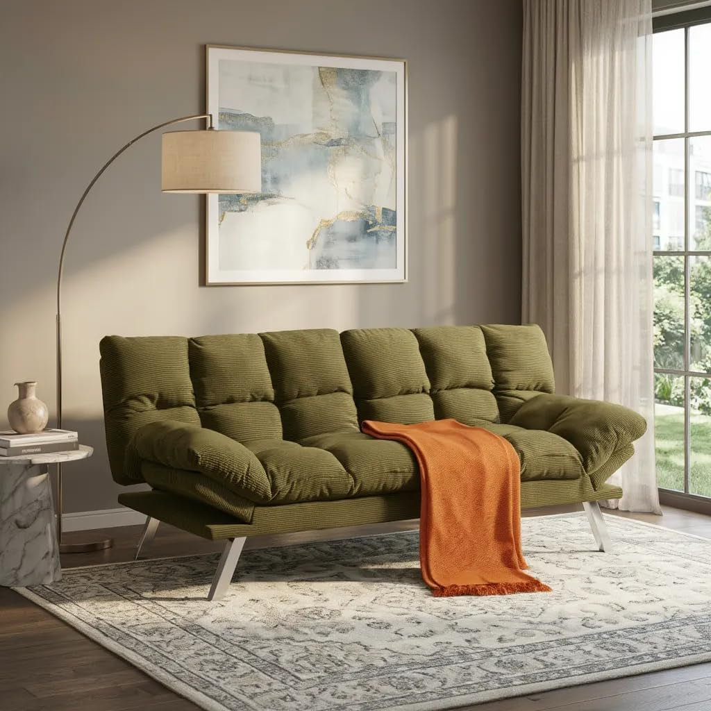 Olive green tufted convertible sofa with angled metal legs and an orange throw.
