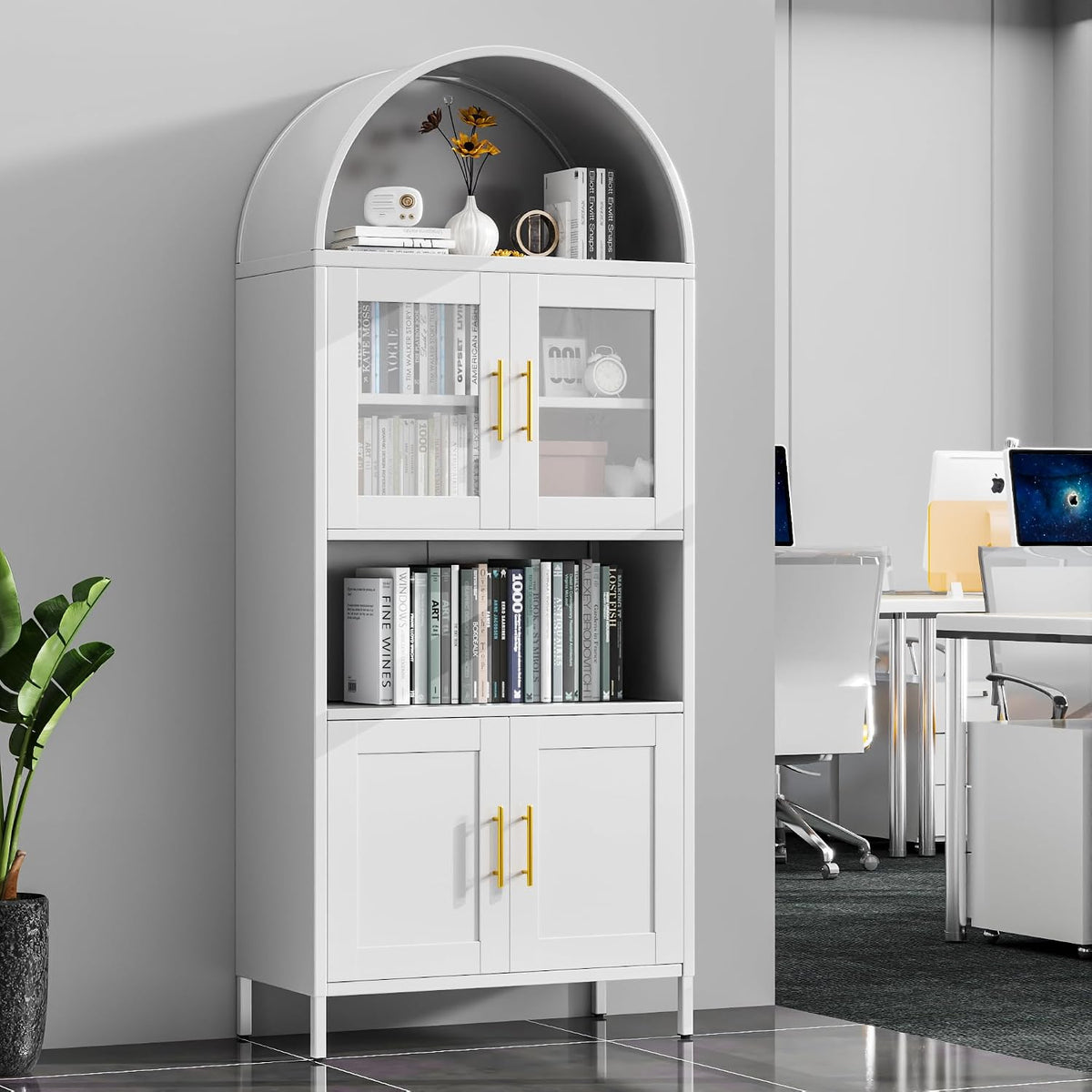 White arched metal bookshelf with glass upper doors, gold handles and styled shelves in an office setting