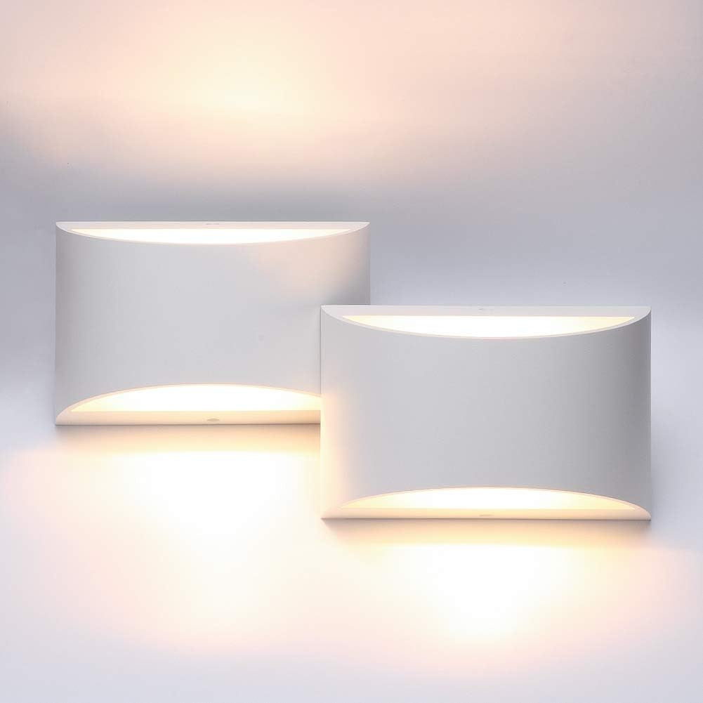 Two white rectangular wall sconces lit side by side, warm light glowing above and below.