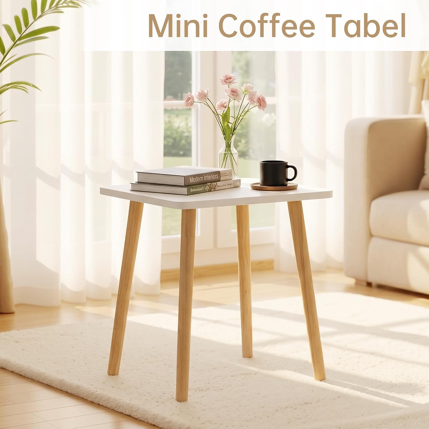 White small side table with natural wood legs shown in bright living room near window with books and vase
