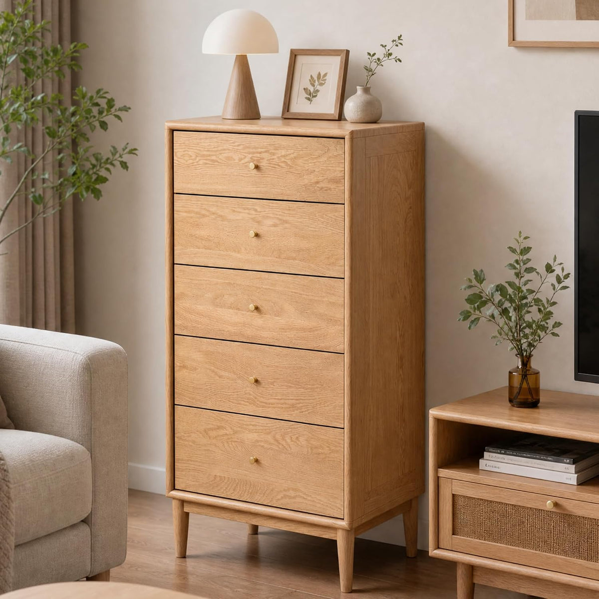 Natural wood five-drawer dresser shown at an angle in a furnished living room