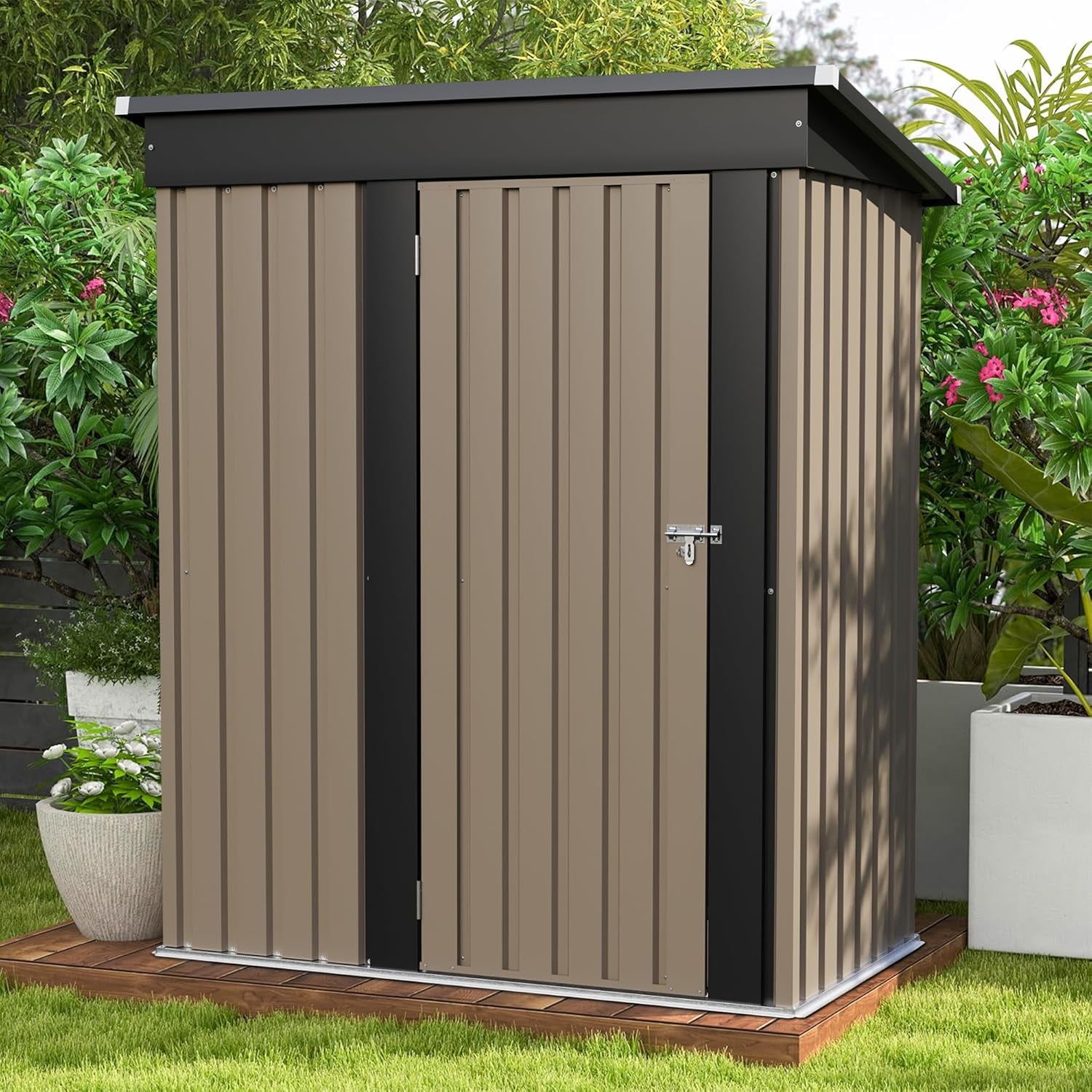 Front view of a small brown metal outdoor shed with a sloping dark trim roof and a lock on the door, placed on a wooden