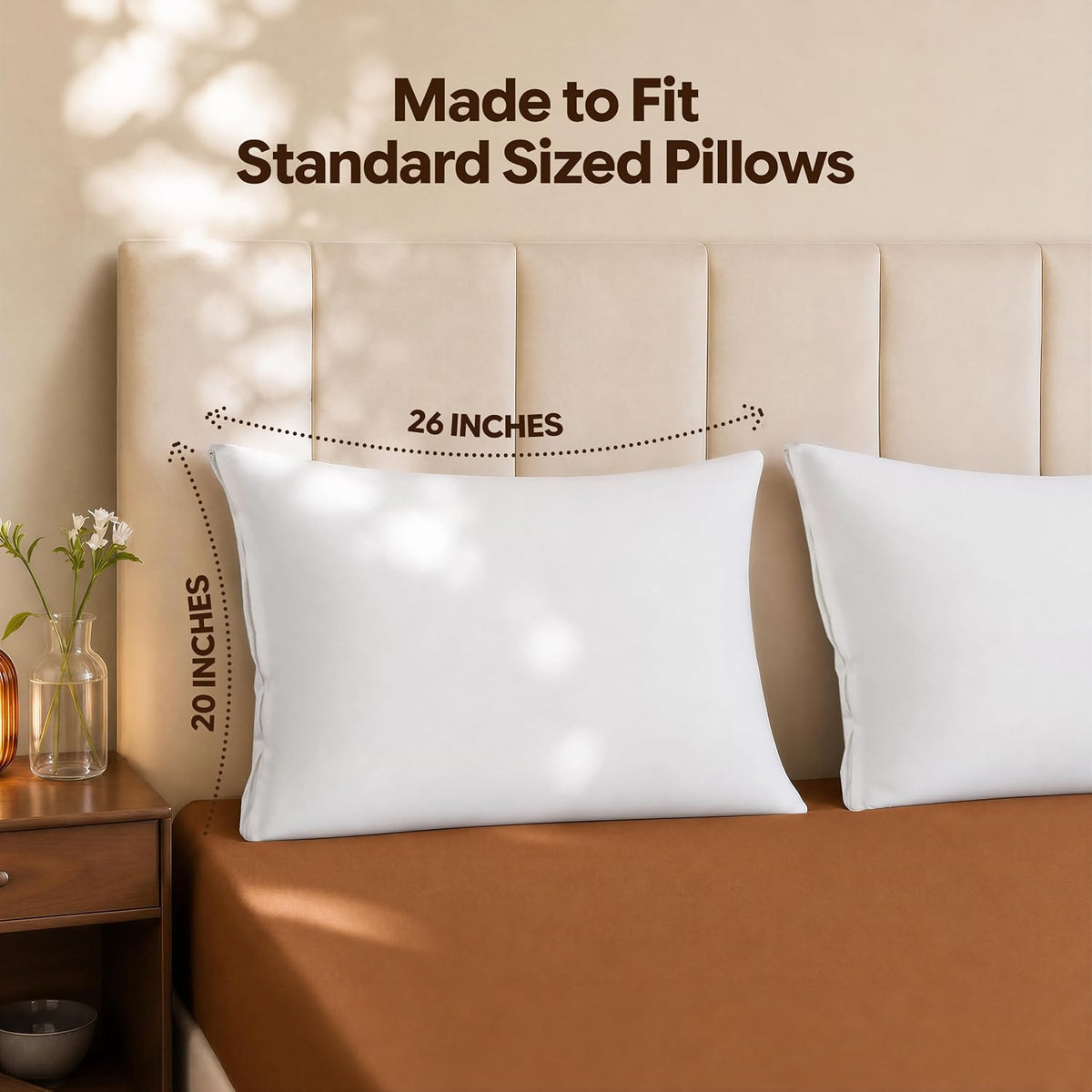 Two white pillow protectors on a bed headboard showing fit for standard-sized pillows with size callouts