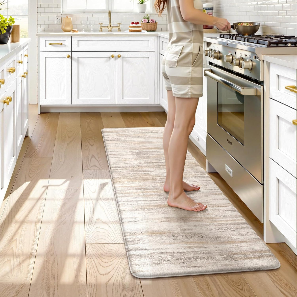Person cooking while standing barefoot on a beige abstract anti-fatigue kitchen mat by the stove.