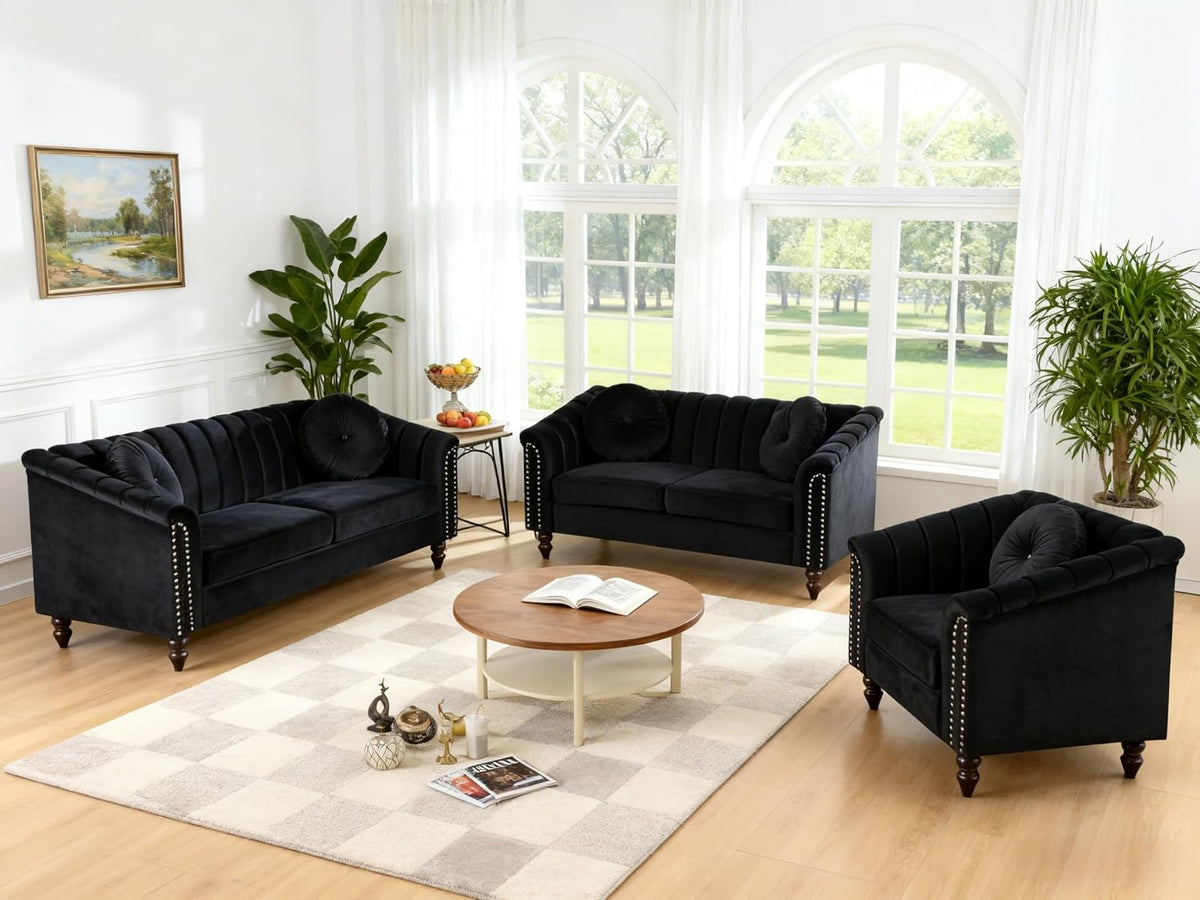 Black velvet Chesterfield 3-piece set (sofa, loveseat, armchair) angled front view in a bright living room