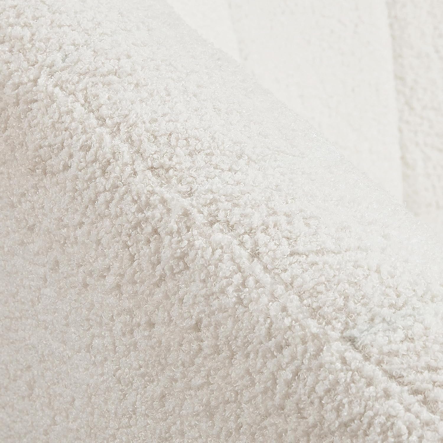 Tight close-up of the ivory bouclé looped fabric texture