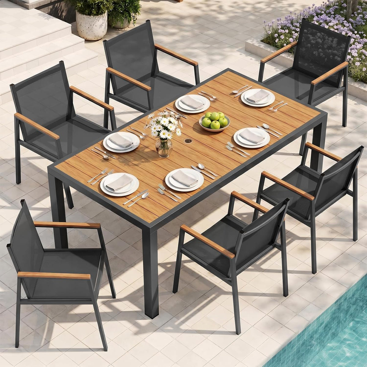 Gray aluminum dining set with faux-wood HDPS rectangular tabletop and six dark textilene armchairs next to a pool, angled top