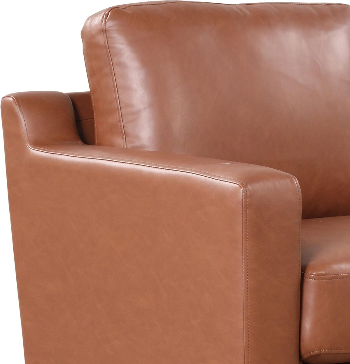 Close-up of sofa arm and back cushion in brown faux-leather showing stitching and texture